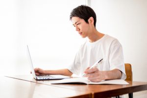 Young,Man,Using,A,Computer