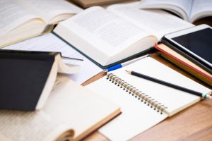 Closeup,Pencil,On,The,Notebook,With,Many,Opened,Books,On