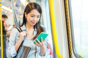 Woman,Using,Hand,Free,And,Looking,On,Mobile,Phone,In