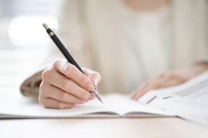 Hands,Of,An,Asian,Woman,Studying,In,A,Coworking,Space